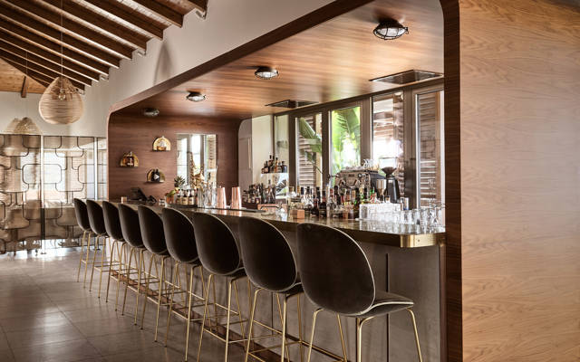 Cabin bar lobby lounge with a long bar with high stools at Eagles Resort